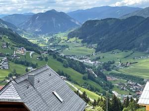 a view of a valley with a house and mountains at Chalet W - auf der Planai -zu jeder Jahreszeit in Schladming