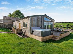 a small cabin with a hot tub in the grass at 2 Bed in Sowerby Bridge 93344 in Ripponden