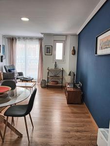 a living room with blue walls and a table and chairs at Alicante airport and beach in El Altet