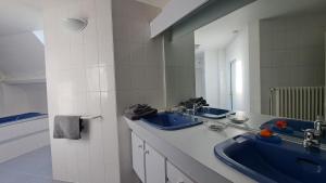 a bathroom with two sinks and a large mirror at Le Beauvais, son gîte, ses chambres en Bourgogne in Saint-Saulge