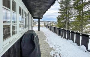 a covered porch of a house in the snow at 4 Bedroom Stunning Home In Svingvoll in Svingvoll