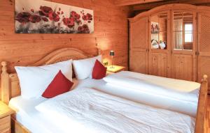 a bedroom with two beds with red pillows at Amazing Apartment In Brandenberg With Wifi in Brandenberg