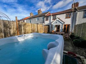 a hot tub in the backyard of a house at Beautiful 04 Berth Cottage With A Private Hot Tub In Norfolk Ref 99002hc in Pentney