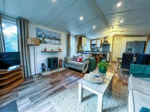 a living room with a couch and a table at Pet Friendly, Luxury Caravan For Hire In Suffolk By The Beach Ref 32203og in Lowestoft