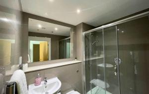 a bathroom with a glass shower and a sink at Bracknell Stylish Two Bedroom Apartment in Bracknell