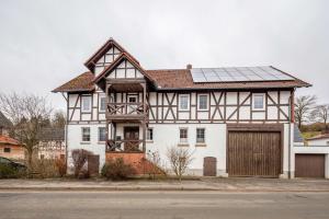 a house with a solar panel on top of it at Ferienwohnung Haseltal in Rotenburg an der Fulda