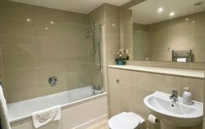 a bathroom with a sink and a toilet and a shower at Bracknell RWH Beautiful Two Bedroom Apartment in Bracknell