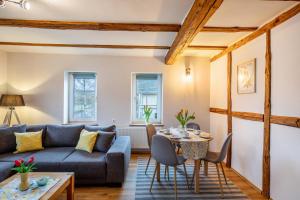 a living room with a couch and a table at Ferienwohnung Haseltal in Rotenburg an der Fulda