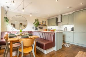 a kitchen with a wooden table and a dining room at Castle House 4 in Wells next the Sea