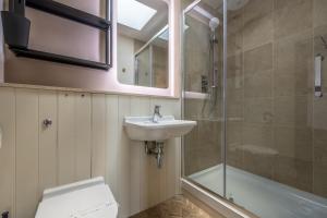 a bathroom with a sink and a shower and a toilet at Castle House 4 in Wells next the Sea