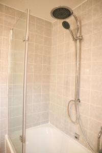 a bathroom with a shower with a shower head at Appartement Sels in Winterberg