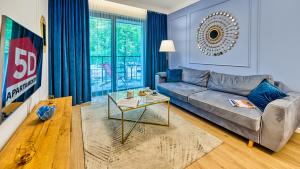 a living room with a couch and a table at Rezydencja Niechorze 225 - 5D Apartamenty in Niechorze