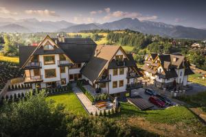 an aerial view of a house with mountains in the background at VisitZakopane - Premium Best View&Spa Apartment in Zakopane