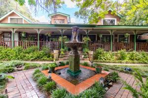 a fountain in the courtyard of a house at Kleine Eden Guesthouse in Bloemfontein
