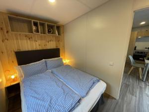 sypialnia z łóżkiem z niebieską kołdrą w obiekcie Holiday Home Tinyhaus am See by Interhome w mieście Wemding