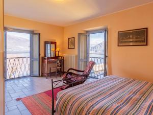 a bedroom with a bed and a balcony at Apartment La Terrazza sul Borgo by Interhome in Bellano