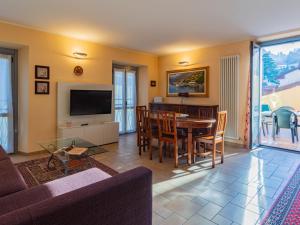 a living room with a table and a dining room at Apartment La Terrazza sul Borgo by Interhome in Bellano