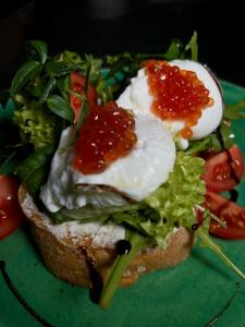 a sandwich with eggs and lettuce and tomatoes on a plate at Imperial Hotel in Bukovel