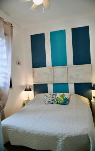 a bedroom with a large bed with blue and white stripes at Azzurro Mare - Cornino in Custonaci