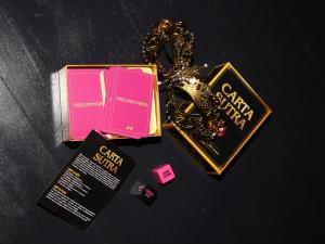a book and a necklace on a table at O' Plaisirs Interdits - Loveroom in Caen