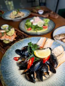 a plate of mussels and vegetables on a table at Imperial Hotel in Bukovel