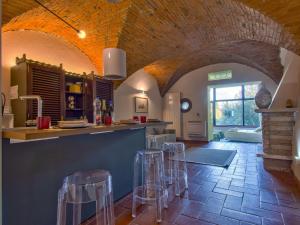 uma cozinha com um balcão e bancos num quarto em Apartment Il Giardino di Lucia by Interhome em San Miniato