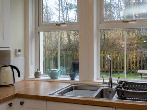 a kitchen with a sink and a window at Holiday Home 1 Railway Cottage by Interhome in Aviemore
