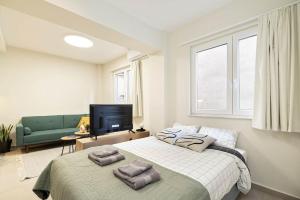 a bedroom with a large bed with towels on it at Exarcheia Nest - Unique Studio in Athens