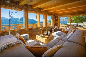 a large living room with couches and a table at Chalet Serbijanka - OVO Network in Manigod
