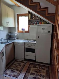 a kitchen with a white refrigerator and a stove at Holiday Home Pharaoh in Visoko