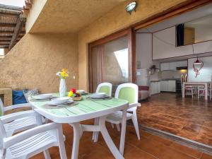 a dining room with a white table and white chairs at Apartment I-1-4 by Interhome in Golfo Aranci
