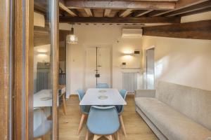 a living room with a table and a couch at Palazzo Borghese Apartment with Panoramic Terrace in Florence