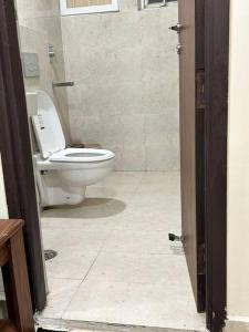 a bathroom with a white toilet in a room at Good Vibes Studio in Zirakpur +13 photos
