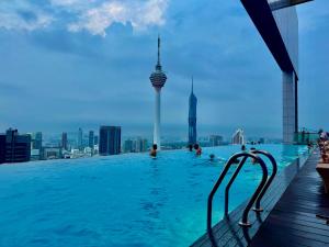 a swimming pool on the roof of a building with a view of the city at Platinum Suites KLCC by Classy in Kuala Lumpur