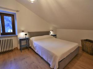 a bedroom with a bed and two night stands at Apartment Guanella Apartment by Interhome in Campodolcino