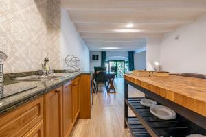 a kitchen with wooden cabinets and a counter top at Bettatur Apartaments Via Imperi Romà in Tarragona
