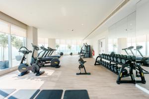 a gym with treadmills and machines in a room at Stayis - 1 BR Marina suite in Dubai