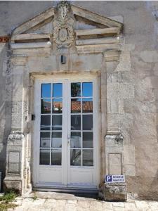 a white door with a sign in front of it at Appartment in a 16th-century castle in La Rochelle