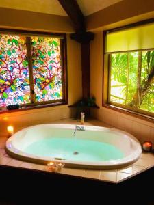 a bath tub in a bathroom with stained glass windows at Pemberton Forest View Retreat in Pemberton