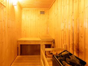 a wooden sauna with a bench and a tub at Villa Craigmore Lodge by Interhome in Aviemore
