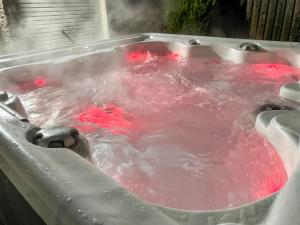 a hot tub filled with red dye in at Villa Craigmore Lodge by Interhome in Aviemore