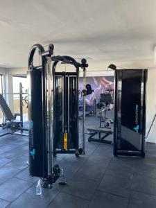 a gym with several treadmills and machines at Palazzo di Milano in Ilhéus