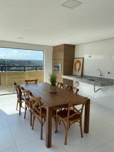 a dining room with a wooden table and chairs at Palazzo di Milano in Ilhéus