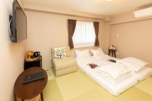 a small room with a bed and a chair at Light Hotel - Vacation STAY 17218v in Tokyo