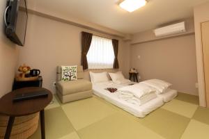 a room with a bed and a chair in it at Light Hotel - Vacation STAY 17218v in Tokyo