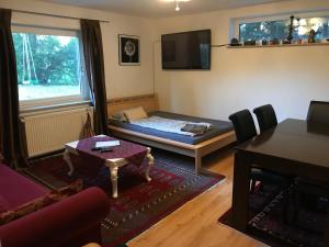 Sala de estar con cama y mesa en Idyllische Wohnung mitten in der Natur „ Haus Magnolia „ en Fischbachtal