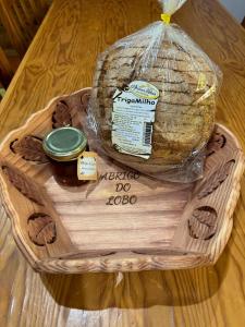 a basket with a loaf of bread and a jar of peanut butter at Mountain Lodge T3 Duplex Abrigo do Lobo in Covilhã