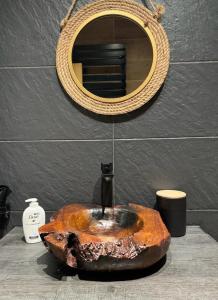 y baño con lavabo de piedra y espejo. en Mountain Lodge T3 Duplex Abrigo do Lobo, en Covilhã