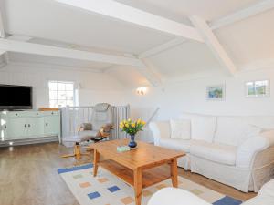 a living room with a couch and a table at Manor Cottage Barn in Callington