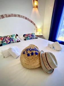 a hotel room with a bed with two hats on it at Résidence U Pirellu in Porto-Vecchio